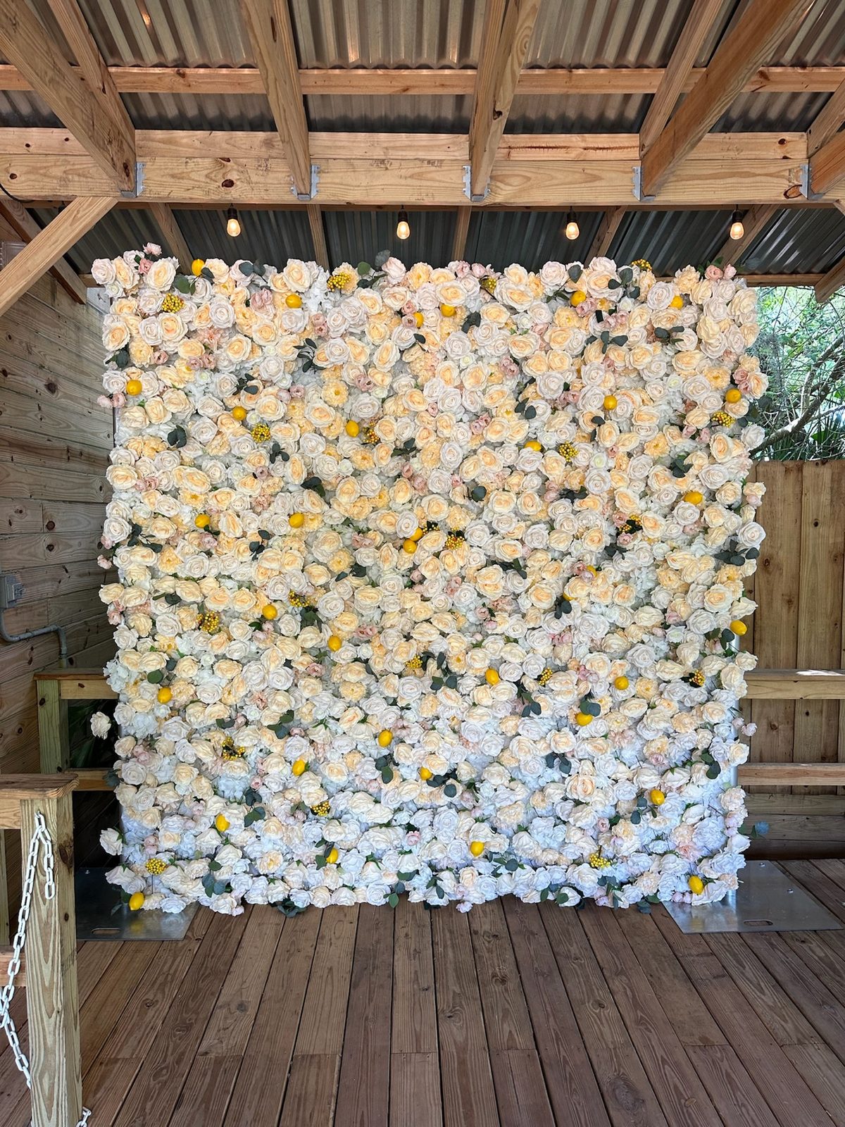 The Yellow Rose with Lemons flower wall with yellow and white flowers and lemon accents